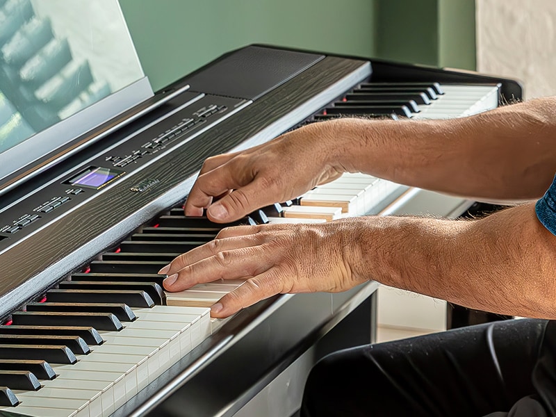 The hands of a person playing the P-525