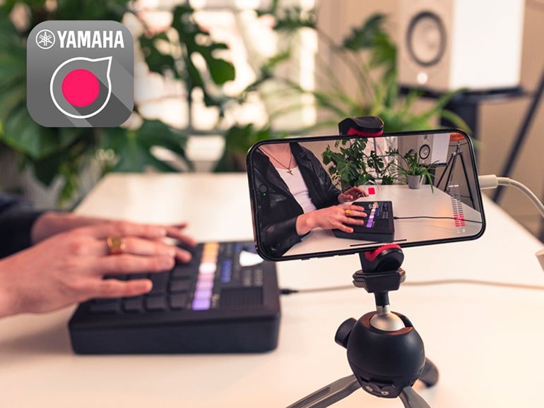 The FGDP-50 is connected to a smartphone via a USB cable and Camera Connection adaptor. The Rec'n'Share App is being used on the smartphone to record a person playing the FGDP-50.