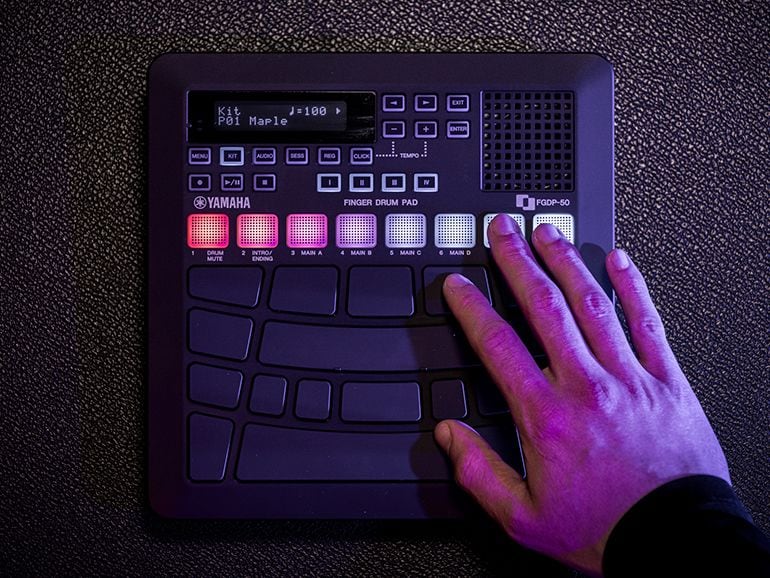 A hand touching the glowing RGD pads of the FGDP-50.