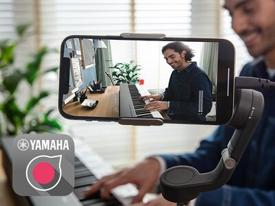 A view of the Yamaha Rec'n'Share app icon and a person taking a smartphone video of them playing