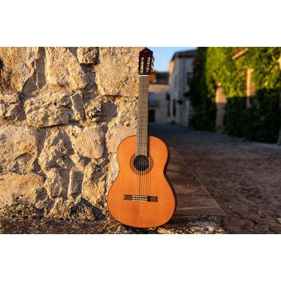 CGX122MC guitar leaning on a stone wall in the street of Pedraza, Segovia during sunset