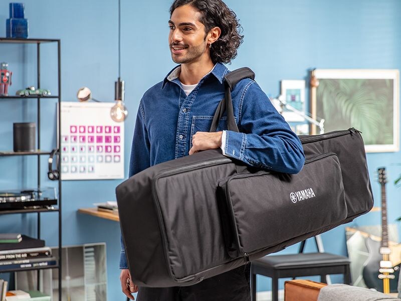 A person carrying the P-225 dedicated keyboard bag on their shoulder