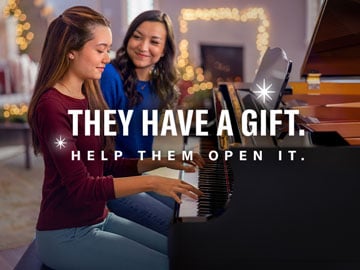 mom and daughter playing Yamaha piano