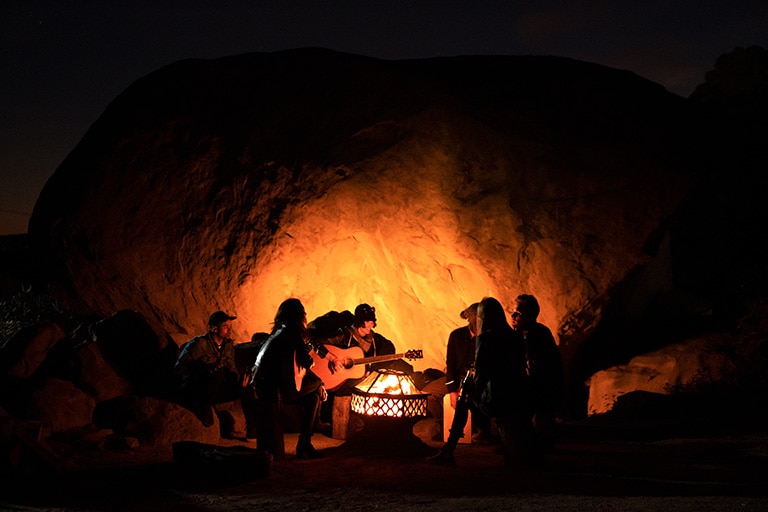 Man playing Guitar with group of people