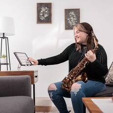 image of a female holding Yamaha Saxohphone