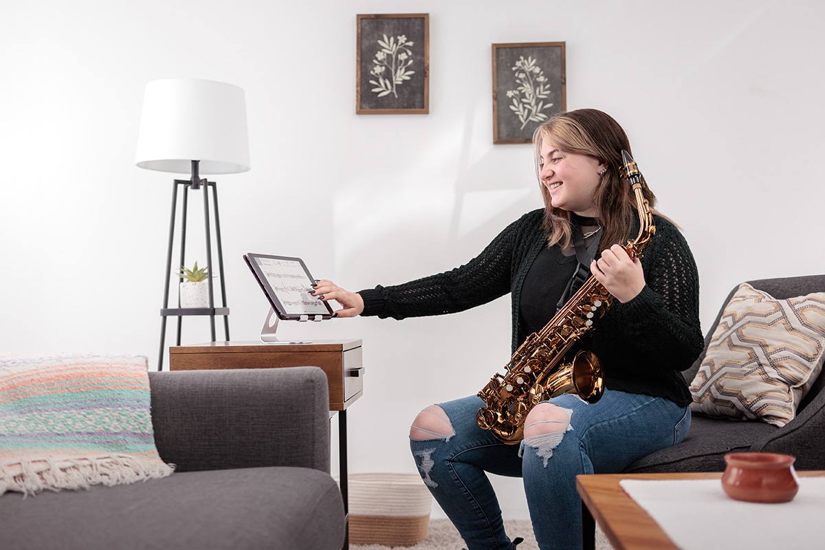 image of a female holding Yamaha Saxohphone