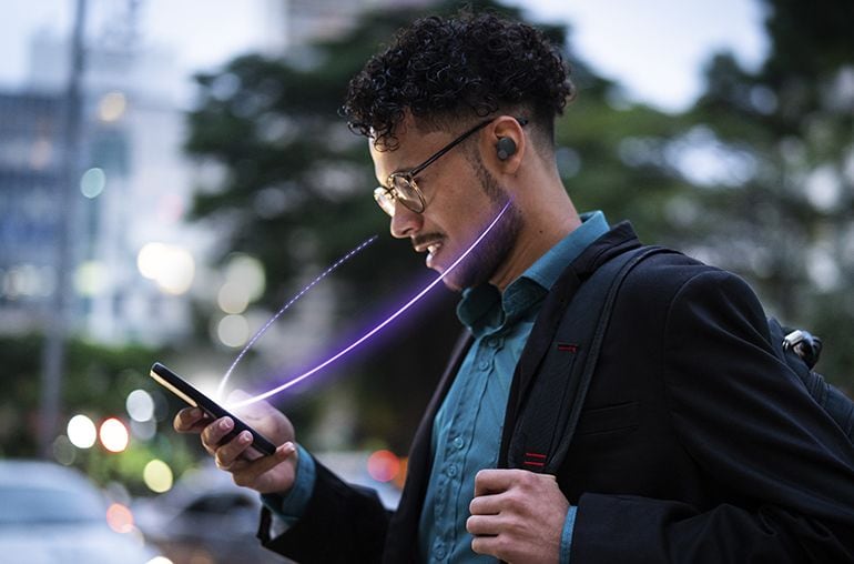 Image of a man looking at the phone wearing TW-E7B earbud