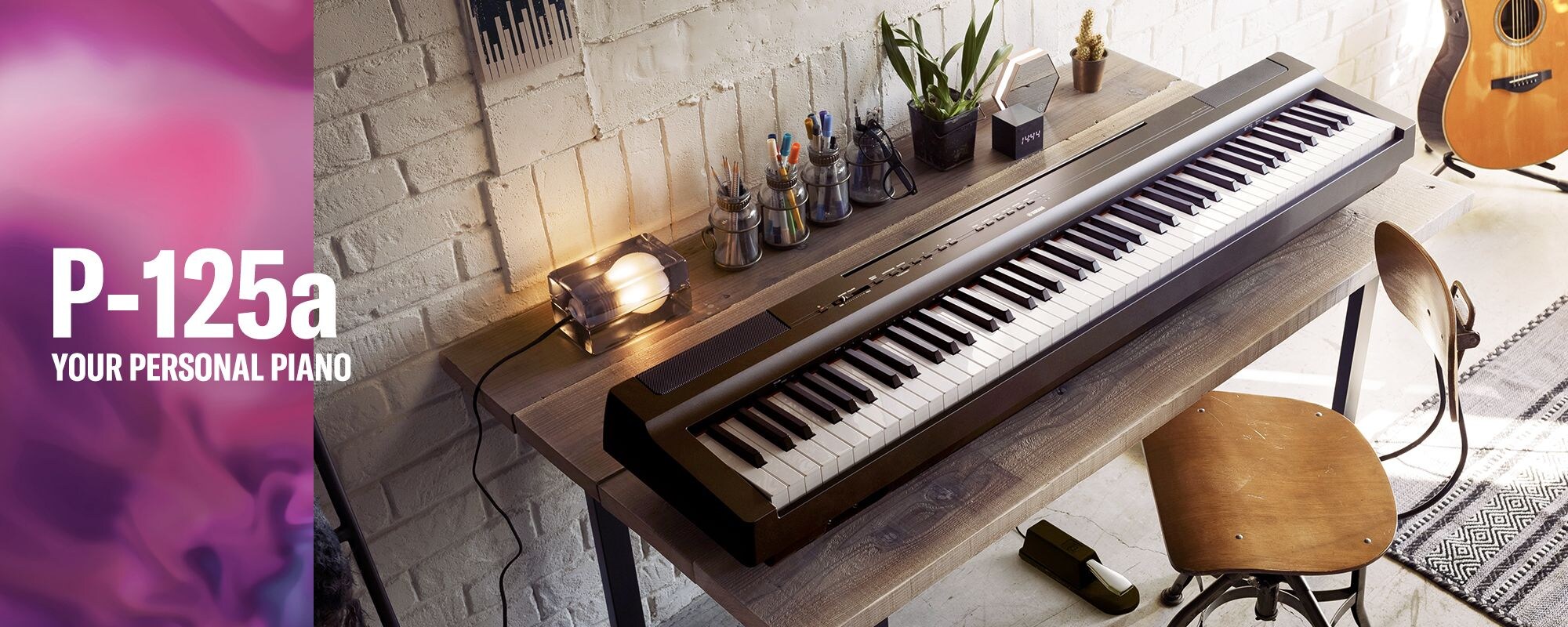 A photo of a Yamaha P-125a digital piano on a desk