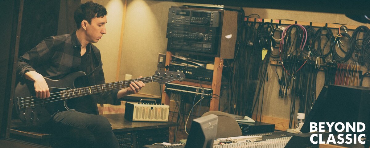 Beyond Classic. Bassist sitting next to a THR while playing BB in a recording space.