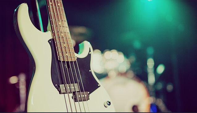 Closeup of BB235 Vintage White with soft focus on drumkit in the background