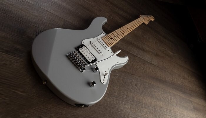 Grey Pacifica 100 Series with rosewood fingerboard laying on ground.